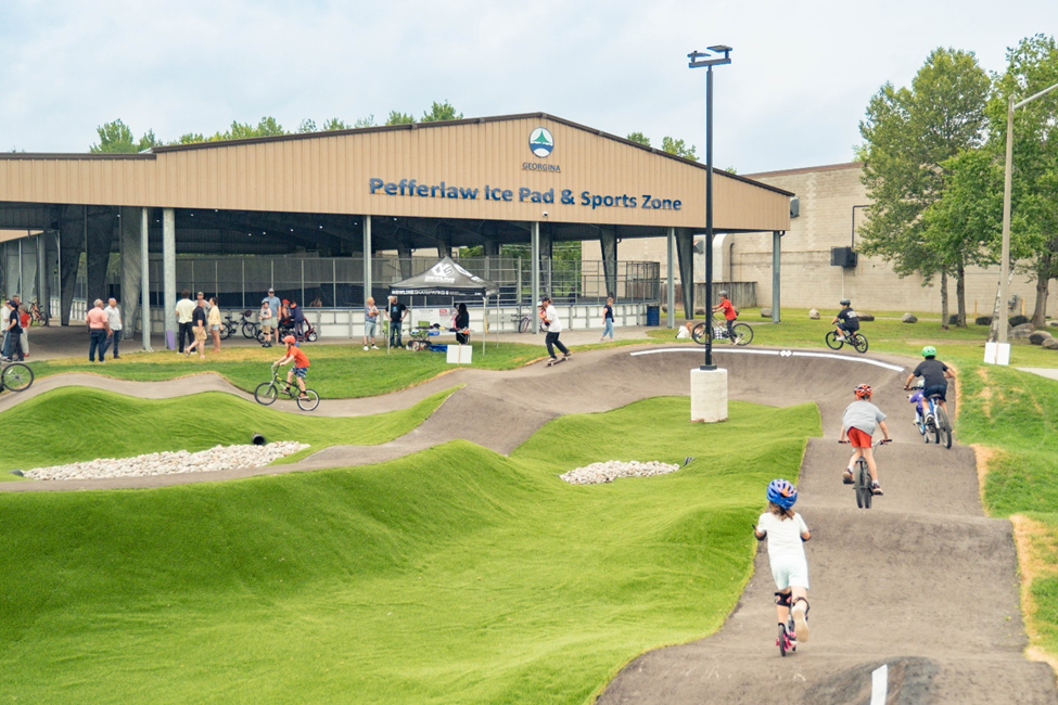 concrete pump track and skate park in front of a building 