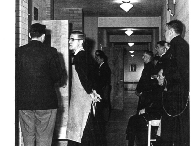 Church service attendees gather in the hallway. Black and white photo.