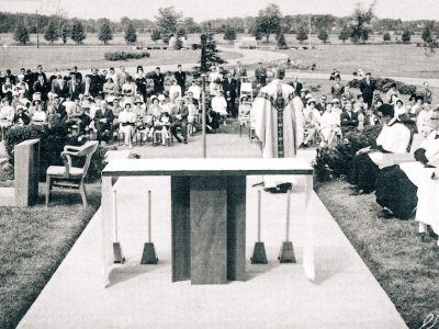 Black and white photo of a religious service outside the Novitiate.